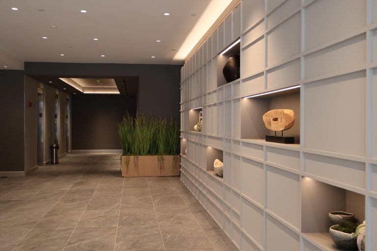 Transformed lobby at 4 Columbus Circle, New York, highlighting custom millwork and contemporary finishes by conceptcsi.
