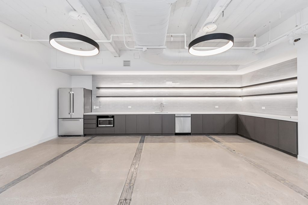 Wide-angle view of office pantry with exposed ceiling at 711 Third Avenue, New York